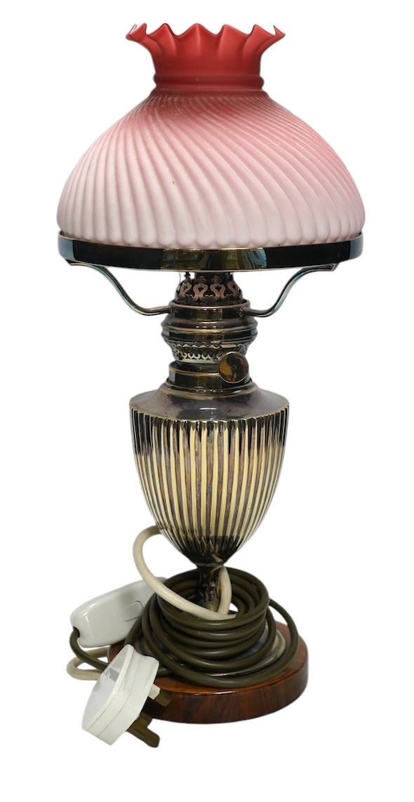 A silver plated table lamp, with a pink satin glass wrythen fluted shade, 41cm high. Condition - shade cracked, lamp untested